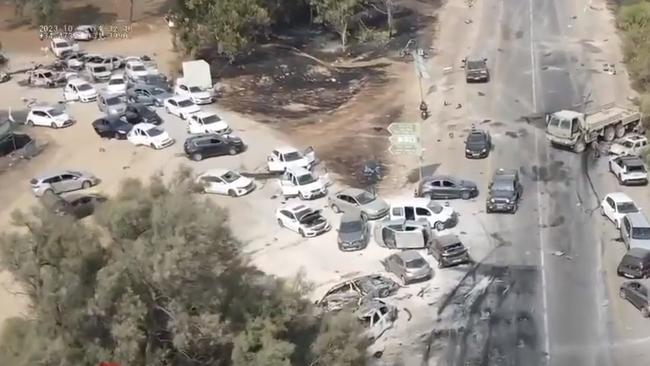 Wrecked cars at the festival site where rescuers found 260 bodies.