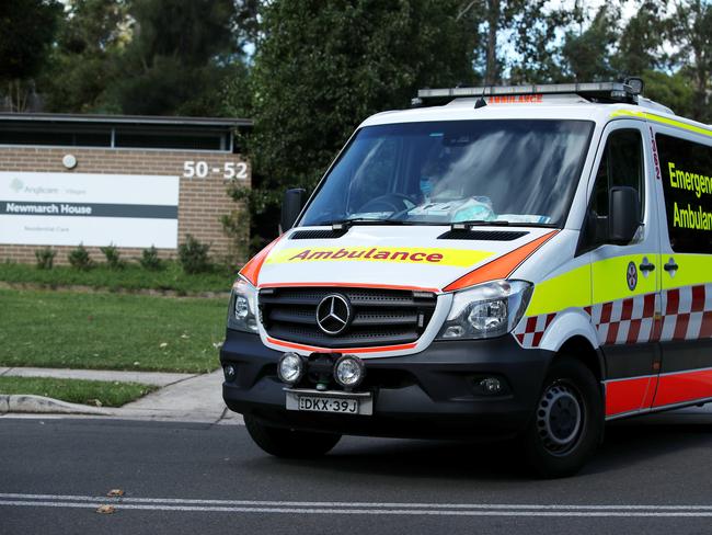 SYDNEY, AUSTRALIA - MAY 01: An New South Wales ambulance leaves Newmarch House with a patient on May 01, 2020 in Sydney, Australia. Four residents at Newmarch House have died after testing positive COVID-19 this week. 11 residents at  aged care home in Western Sydney have now died of coronavirus (COVID-19) after a part time care worker tested positive at the start of April. Newmarch House has recorded 54 positive coronavirus cases - 20 staff and 34 residents - so far. (Photo by Cameron Spencer/Getty Images)