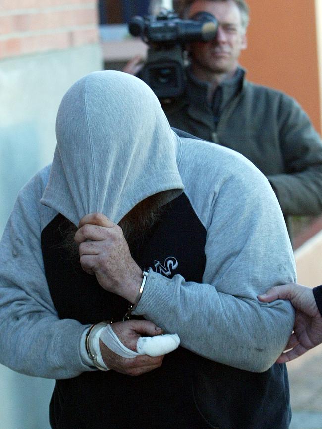 Murder Trial of David John Wright, David John Wright hides his face as he is taken to the Burnie Supreme Court