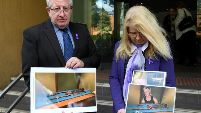 Mark and Faye Leveson hold a photograph of their son Matthew and his skeletal remains at the inquest at the NSW Coroners Court in Sydney. Picture: AAP Image/Dan Himbrechts