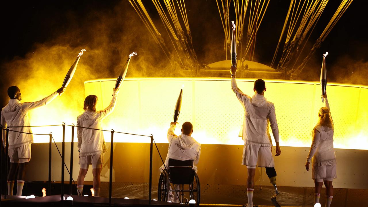 From left, France's Paralympic torchbearers, Charles-Antoine Kaoukou, Elodie Lorandi, Fabien Lamirault, Alexis Hanquinquant and Nantenin Keita light the cauldron at the close of the ceremony at the Jardin des Tuileries (Tuileries Garden) in Paris on August 28. Picture: Franck Fife/AFP