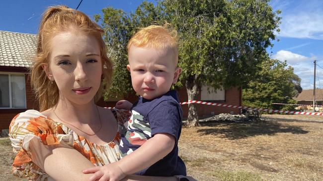 Annalise Madigan and son Blake stand in front of their home which was next to the property that went up in flames on Monday night. Picture: Todd Lewis