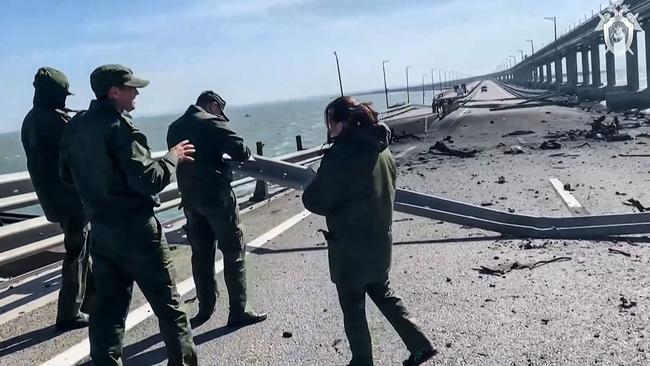 Russian inspectors work on the Kerch bridge, linking Crimea to Russia, after it was heavily damaged following a truck bomb explosion. Picture: AFP/Russian Investigative Committee