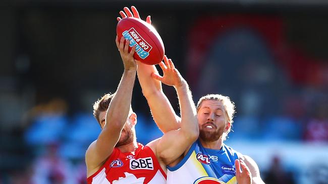 Aaron Young attempts to spoil Swan Harrison Marsh during the Suns’ big win on Saturday. Picture: Mark Kolbe/Getty Images