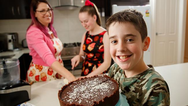 Kerryn Ciracovitch, who runs business The Spatularette, and children Brady, 11, and Charlotte, 14, in the kitchen making a Philadelphia cheesecake. Picture: Matt Turner