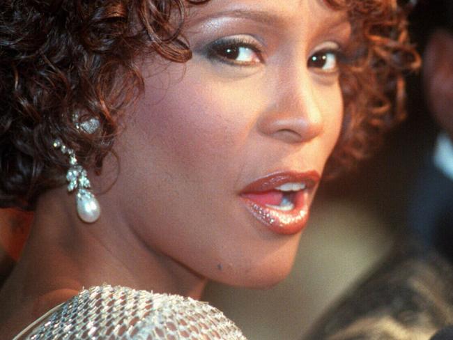 Whitney Houston with her husband Bobbi Brown  the premiere of movie "Cinderella," at Mann's/Chinese/Theatre in  Los/Angeles Oct. 13, 1997. (AP Photo Rene/Macura) USA actress music singers headshot