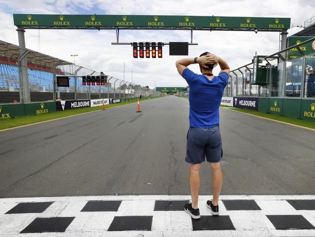 Track doctor Ashley Hague stands on the finish line in disbelief after the event was cancelled due to coronavirus in 2020. Picture: David Caird