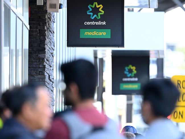 MELBOURNE, AUSTRALIA - MARCH 24: Peopler queue to enter Centrelink on March 24, 2020 in Melbourne, Australia. Non-essential travel has been banned in a bid to stop the spread of COVID-19 in Australia while venues such as bars, clubs, nightclubs, cinemas, gyms and restaurants, along with anywhere people remain static are now closed. Schools are currently open but parents have the option to keep children at home if they wish. There are now 1887 confirmed cases of COVID-19 in Australia and the death toll now stands at eight. (Photo by Quinn Rooney/Getty Images)