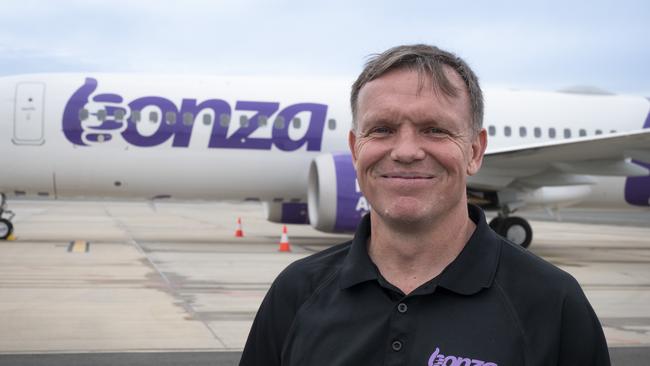 Bonza CEO Tim Jordan stands in front of the low-cost airline's first plane at Sunshine Coast Airport.