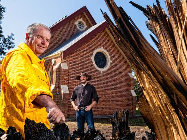 The Holy Trinity church in Cudgewa saved by  firey. Fire came close but didn't burn down the church.  Cudgewa CFA captain Paul Carkeek and father Mitchell Porter. Picture: Simon Dallinger