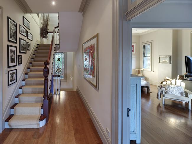 A tall cedar staricase leads upstairs to the main bedroom.