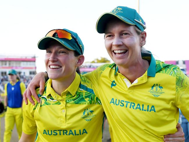 BIRMINGHAM, ENGLAND - AUGUST 07: Megan Schutt and Meg Lanning of Team Australia celebrate after winning the gold medal following the Cricket T20 - Gold Medal match between Team Australia and Team India on day ten of the Birmingham 2022 Commonwealth Games at Edgbaston on August 07, 2022 on the Birmingham, England.  (Photo by Alex Davidson/Getty Images)