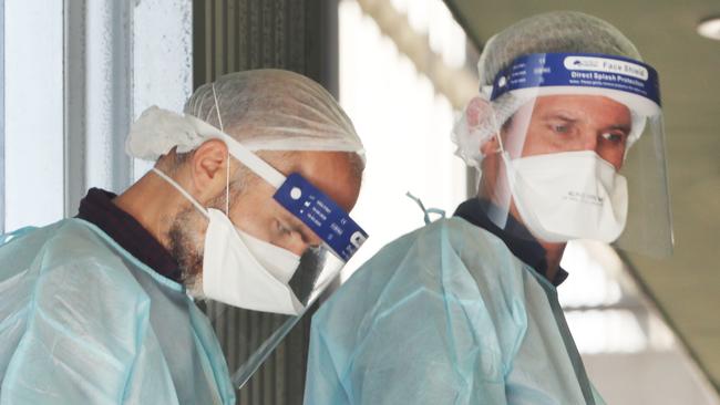 Medical staff at a public housing block in Broadmeadows linked to the Grade 5 student. Picture: David Crosling