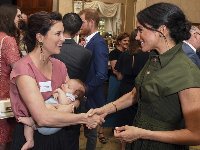 Meghan meets singer Missy Higgins, who is cradling her nine-week-old baby Luna. Picture: AP