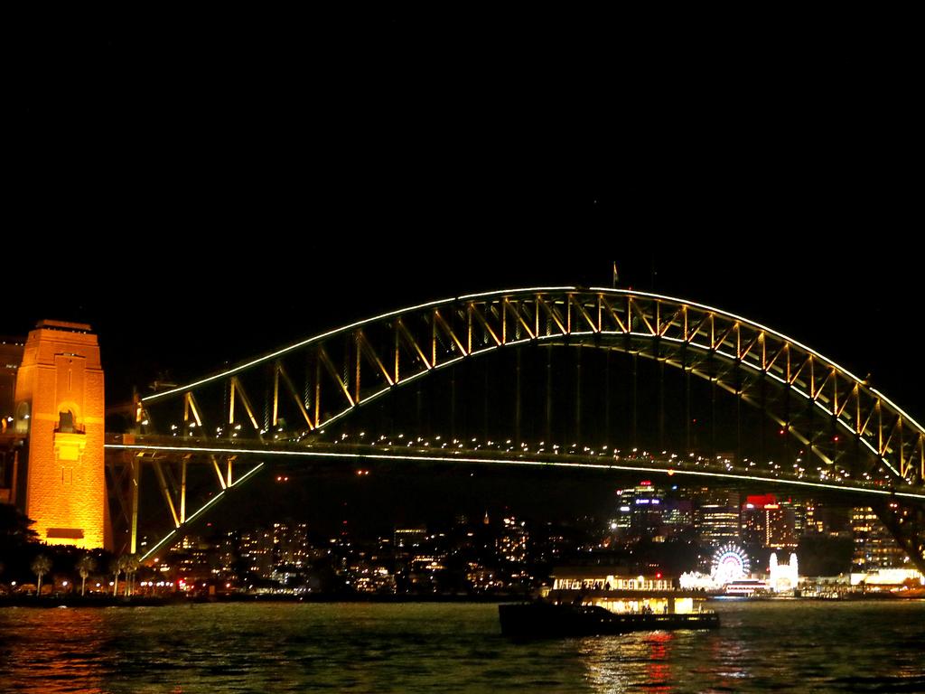 The Sydney Harbour Bridge is seen yellow as part of the Yellow Ribbon National Road Safety Week. Picture: AAP Image/Daniel Munoz