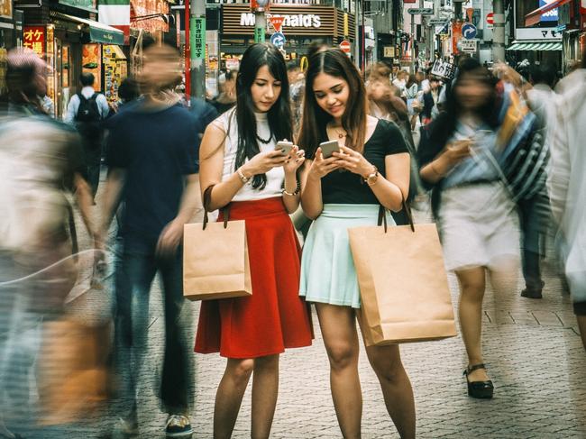 ESCAPE: Japanese girls with mobile phones hanging out on Shibuya streets of Tokyo, Japan for Best for 2017 Cover story by Simon Tsang. Picture: iStock