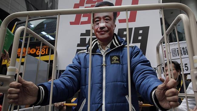 A protester wearing a mask of missing bookseller Lee Bo in Hong Kong.