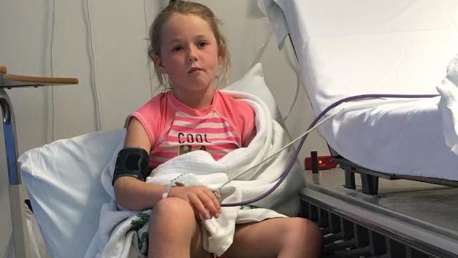 Gracie Mawn, 7, in hospital after she was stung by a stone fish at Golden Beach on Queensland's Sunshine Coast. Her father Chris Mawn has slammed Australian airline Jetstar for refusing to refund him the full $600 he paid to reschedule her and her mother's flights home. Picture: AAP/Supplied.