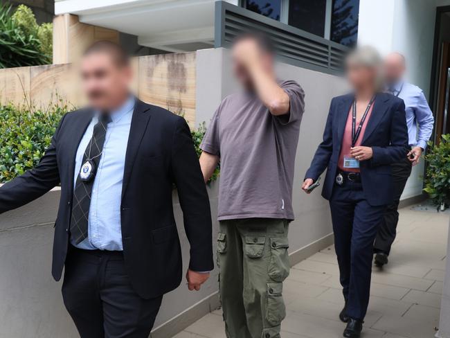 Organised Crime Squad detectives will extradite Eddie Hayson (centre) from the Gold Coast to Sydney following an investigation into alleged commercial drug supply around Australia under Strike Force Maimura. Picture: NSW Police