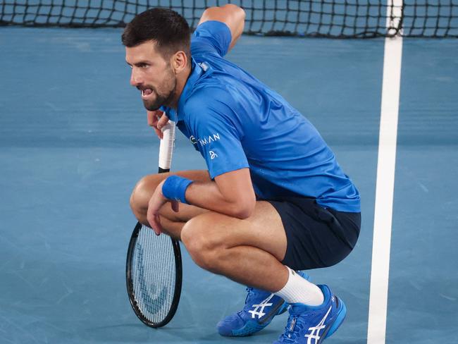 Serbia's Novak Djokovic reacts from an injury while playing against Spain's Carlos Alcaraz during their men's singles quarterfinal match on day ten of the Australian Open tennis tournament in Melbourne on January 21, 2025. (Photo by DAVID GRAY / AFP) / -- IMAGE RESTRICTED TO EDITORIAL USE - STRICTLY NO COMMERCIAL USE --