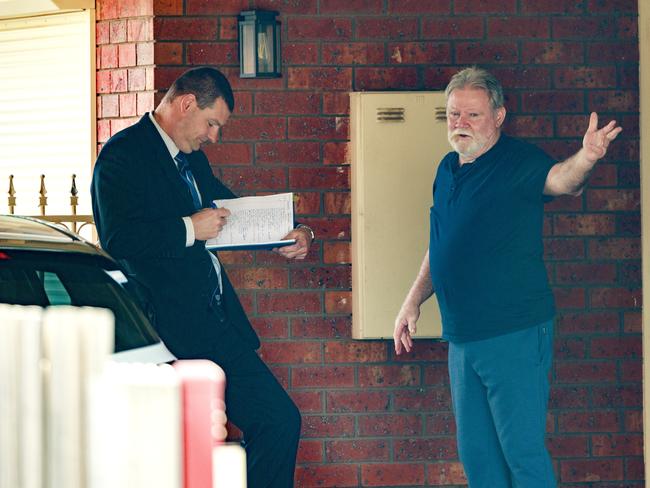 A Detective talks to a neighbour near the scene of a shooting in Hoppers Crossing. Picture: David Geraghty