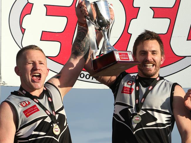 Roxburgh Park captain Harley Short and playing coach Michael Farrelly show off the silverware after last season’s grand final triumph. Picture: Hamish Blair