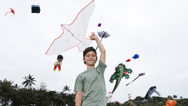 Gus Faber, 10, has fun flying a kite which is dwarfed by the huge kites flying above Four Mile Beach when the attended Port Douglas Carnivale's family beach day on Saturday. Picture: Brendan Radke