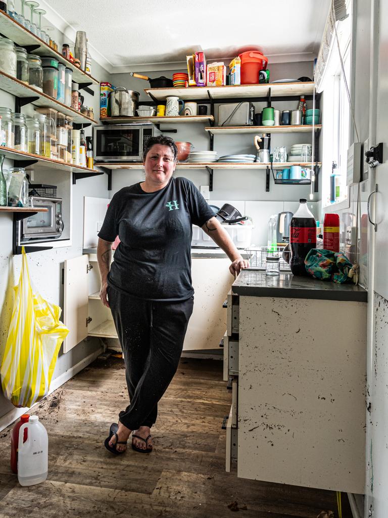 Clean-up continues in Hervey Bay Narelle Arthur in the kitchen of her home, marks show the water was waist high. Photo Paul Beutel