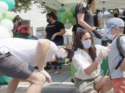 The couple help out a young boy at the event. Picture: Instagram