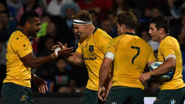 Wallabies winger Reece Hodge celebrates with teammates after scoring a try against Argentina.