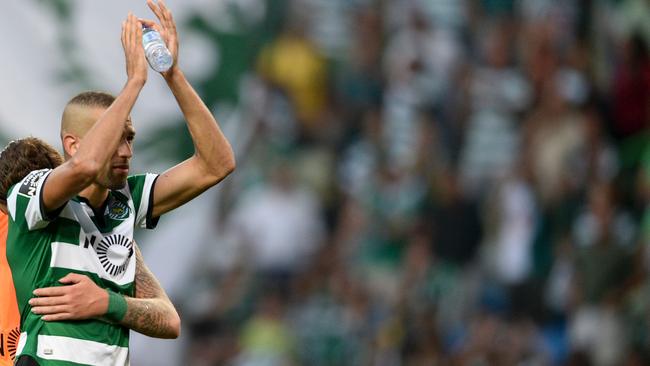 Sporting's Algerian forward Islam Slimani (R) waves goodbye to his supporters.