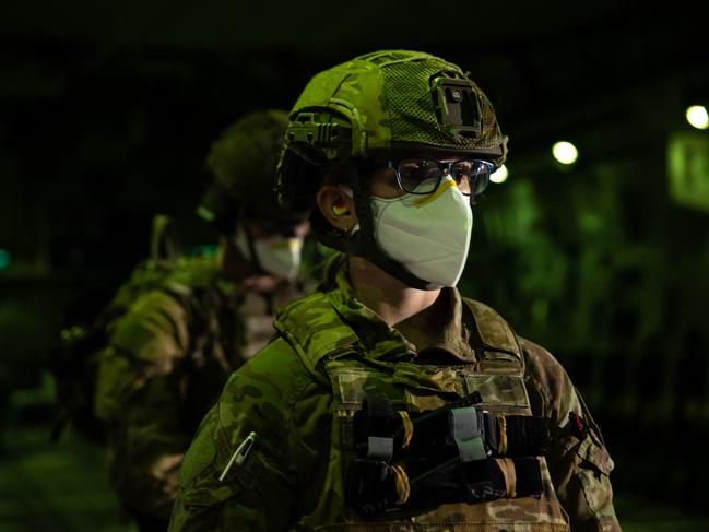 Royal Australian Air Force Mobile Air Load team member, Corporal Teneale Olm prepares to assist in the embarkation of Australian citizens and visa holders onto a RAAF C-17A Globemaster, on the flight line of Hamid Karzai International Airport. *** Local Caption *** A Royal Australian Air Force C-17A Globemaster III aircraft has joined evacuation operations conducting the second Australian Defence Force flight evacuating Australian nationals and approved foreign nationals from Hamid Karzai International Airport in Kabul, Afghanistan.  The aircraft is now part of a fleet of two C-17A Globemaster III aircraft, two C-130J Hercules aircraft and a KC-30 Multirole Tanker Transport aircraft deployed in support to Australian and coalition evacuation operations.