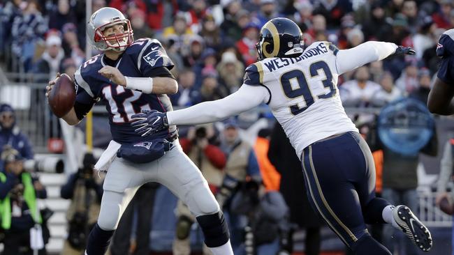 New England Patriots quarterback Tom Brady passes under pressure.