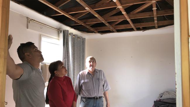 Builder Dean Morante inspects the damage to the inside of Ken and Elizabeth Harris’s Shailer Park home.