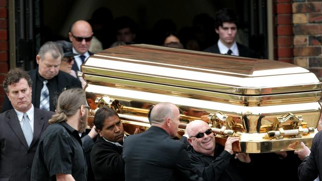 Carl Williams’ gold coffin is carried from his funeral service at a church in Essendon.