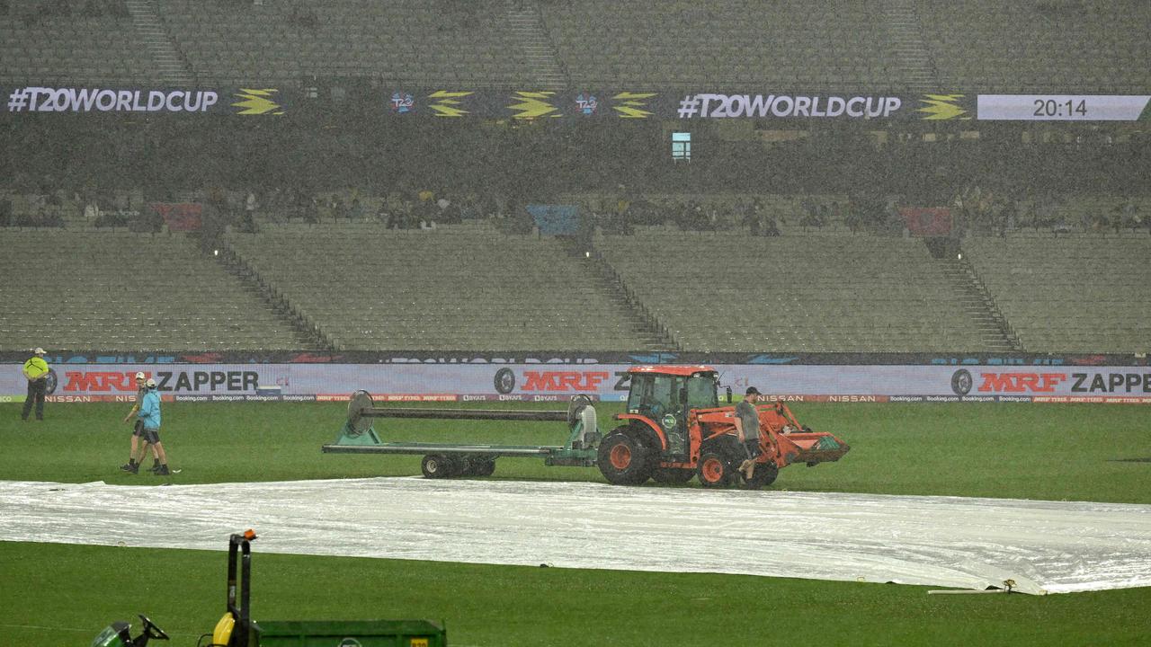 Ground staff at the MCG put the covers on during a washed out Super 12 match.