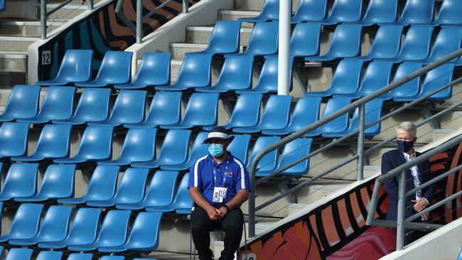 Tennis Australia chief executive Craig Tiley, right, has a look at the doubles action amid the empty seats on court three. Picture: Michael Klein