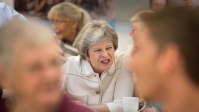 Britain's Prime Minister Theresa May talks with people attending a social group in south London, in October, where she launched the government's loneliness strategy. Picture: Stefan Rousseau/AFP