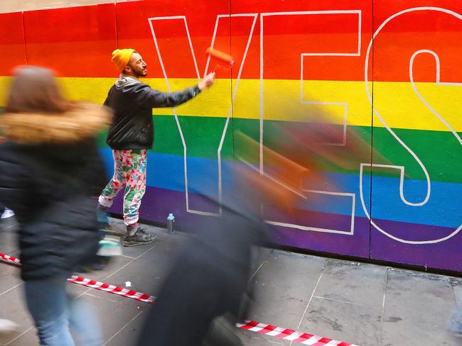 Artist David Pereirra paints a pro-gay marriage mural on a wall at Melbourne Central on August 27, 2017 in Melbourne, Australia. Picture: Getty.