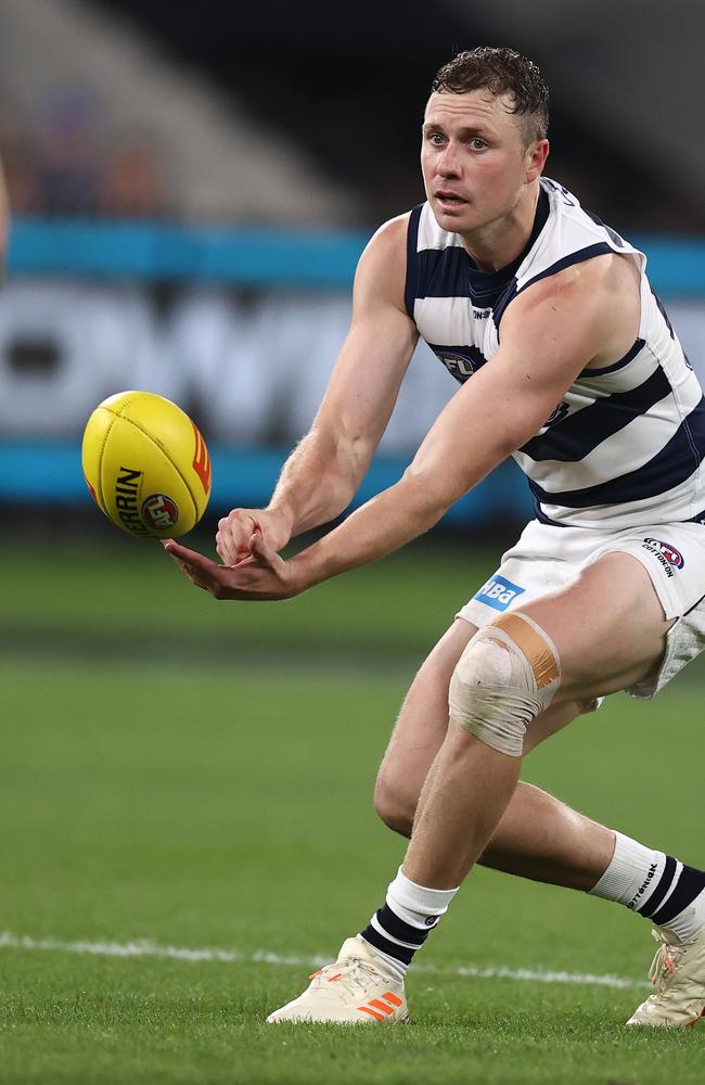 Mitch Duncan fires a handball. Pic: Michael Klein