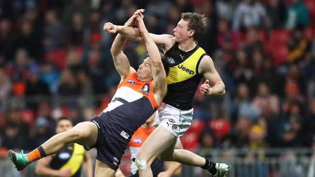 Dylan Grimes spoils the ball away from Toby Greene.