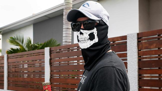 A masked resident of neighbourhoods south of the capital, stands near a roadblock set-up to block access. Picture: Delphine Mayeur