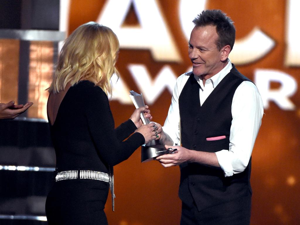 Kiefer Sutherland presents the Female Vocalist of the Year award to recording artist Miranda Lambert onstage during the 51st Academy of Country Music Awards. Picture: AFP