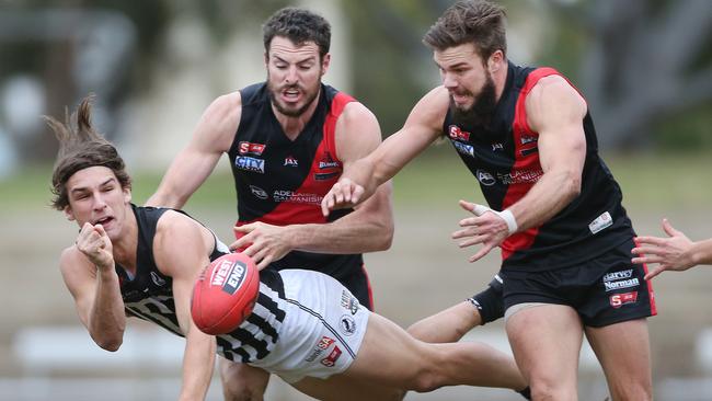 Hard working ... Port Adelaide’s Jesse Palmer (Port Adelaide) handballs against West Adelaide.  Picture: Stephen Laffer