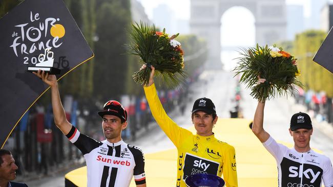 Geraint Thomas with second-placed Netherlands' Tom Dumoulin (L) and third-placed Great Britain's Christopher Froome (R) celebrate the top three overall spots in this year’s Tour de France. / AFP PHOTO / POOL / STEPHANE MANTEY