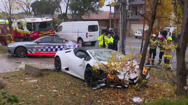 The Lamborghini crashed through the brick fence of a home, over an electrical box, and into a tree. Picture: TNV