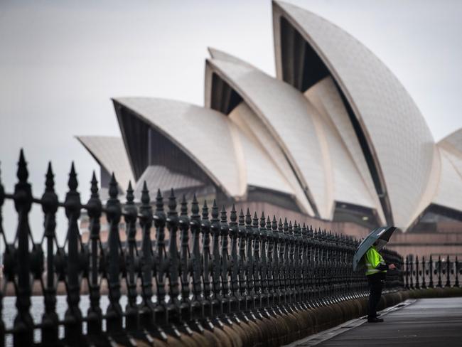 Sydney woke up on 24th October 2020 with the dreary calm b before the storm as wet and wild weather is forecast for the city. Generic scenes of people out and about near Sydney Harbour Bridge in The Rocks as day breaks.(Pictures by Julian Andrews).