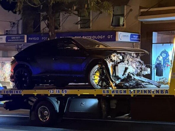 The Lamborghini on the back of a tow truck after the crash.