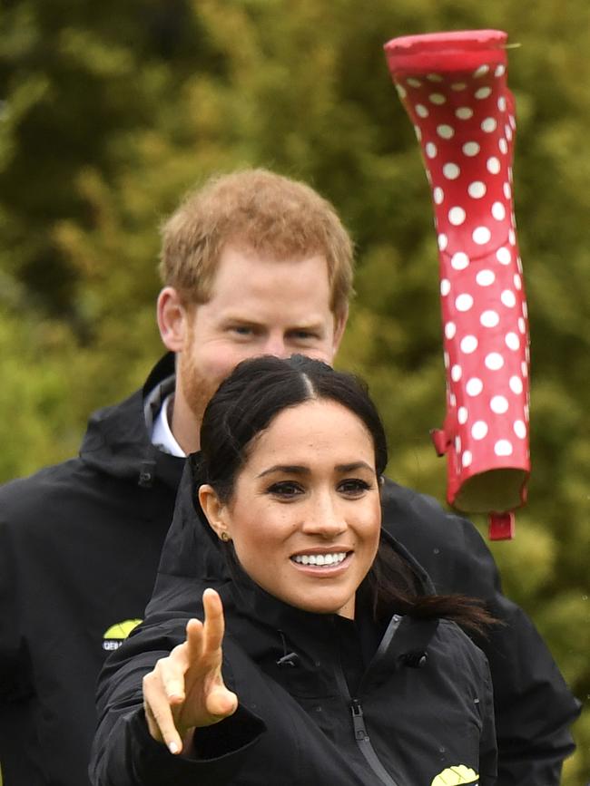 With a flick of the wrist, Meghan wins bragging rights in the welly wanging. Picture: Dominic Lipinski/AP