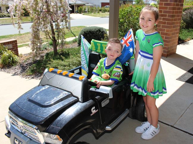 Cooper with his sister Miley, 8, with the real Green Machine.